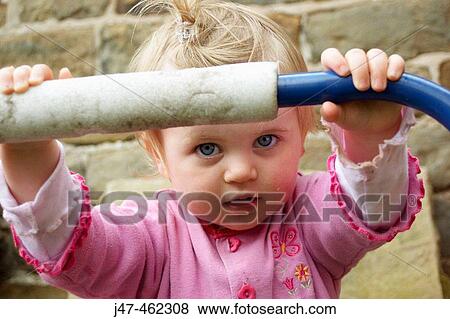 18 month old girl holding onto a trampoline, huge blue eyes View Large Photo Image Stock Photo - 18 month old girl holding onto a trampoline, huge blue eyes. Fotosearch