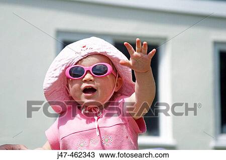 18 month old girl in sunglasses and sunhat waving to the camera View Large Photo Image Stock Image - 18 month old girl in sunglasses and sunhat waving to the camera. Fotosearch