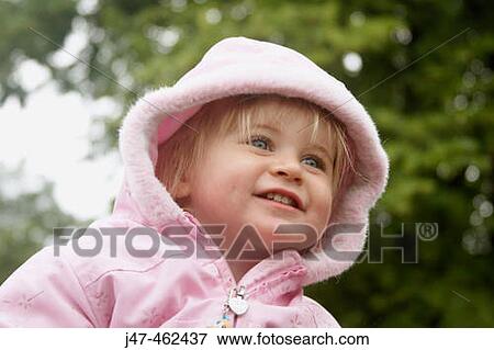 18 month old girl outside, with her hood up, smiling View Large Photo Image Stock Photo - 18 month old girl outside, with her hood up, smiling. Fotosearch