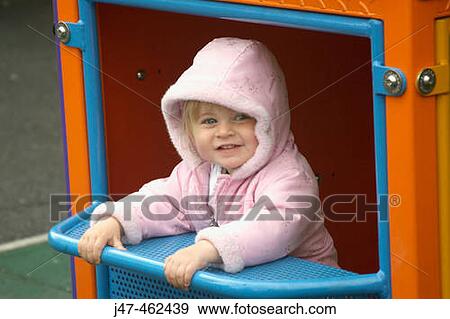 18 month old girl playing in a park, with her hood up View Large Photo Image Stock Photo - 18 month old girl playing in a park, with her hood up. Fotosearch