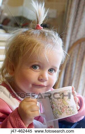 18 month old girl sitting having a drink looking into camera View Large Photo Image Stock Photography - 18 month old girl sitting having a drink looking into camera. Fotosearch