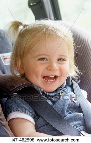 18 month old girl sitting in her car seat laughing into camera View Large Photo Image Stock Photo - 18 month old girl sitting in her car seat laughing into camera. Fotosearch