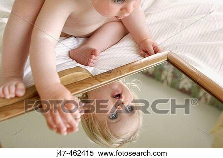 18 month old girl sitting leaning over a mirror View Large Photo Image Stock Photography - 18 month old girl sitting leaning over a mirror. Fotosearch