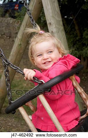 18 month old girl smiling on a swing View Large Photo Image Stock Image - 18 month old girl smiling on a swing. Fotosearch