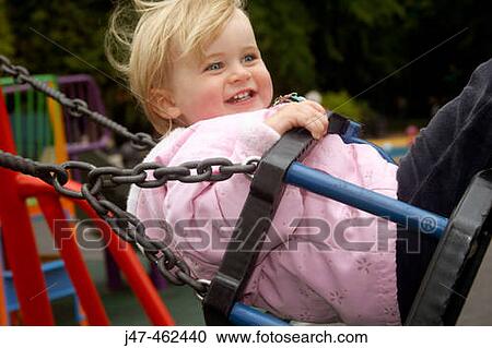 18 month old girl swinging, smiling View Large Photo Image Stock Image - 18 month old girl swinging, smiling. Fotosearch
