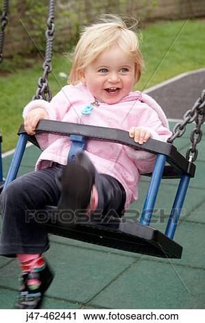 18 month old girl swinging, smiling View Large Photo Image Stock Image - 18 month old girl swinging, smiling. Fotosearch