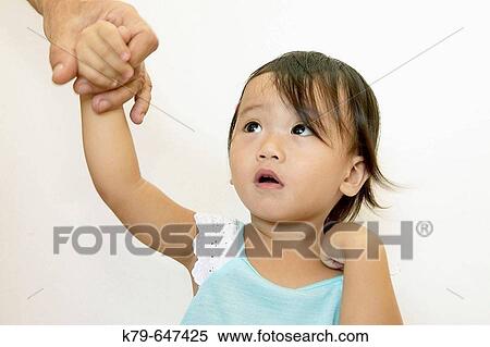 18 month old half Chinese/Philippines girl holding father's hand. View Large Photo Image Stock Photography - 18 month old half Chinese/Philippines girl holding father's hand.. Fotosearch