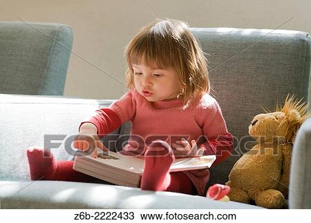 18 months old baby girl looking and pointing at inside a book. View Large Photo Image Stock Image - 18 months old baby girl looking and pointing at inside a book.. Fotosearch
