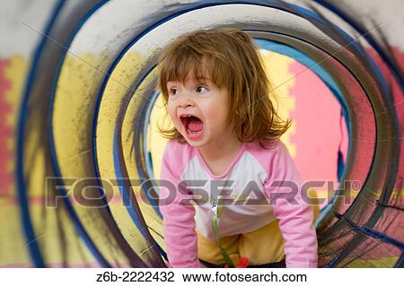 19 months old baby girl playing inside a tunnel. View Large Photo Image Stock Image - 19 months old baby girl playing inside a tunnel.. Fotosearch