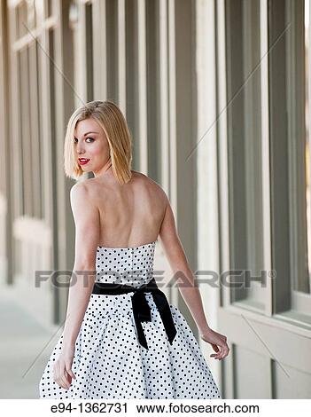 19 year old blond woman walking on a sidewalk in a small town wearing dress View Large Photo Image Stock Image - 19 year old blond woman walking on a sidewalk in a small town wearing dress. Fotosearch