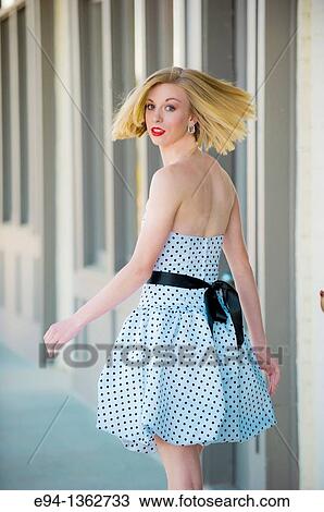 19 year old blond woman walking on a sidewalk in a small town wearing dress View Large Photo Image Stock Image - 19 year old blond woman walking on a sidewalk in a small town wearing dress. Fotosearch