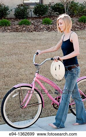 19 year old blond woman with a pink bicycle View Large Photo Image Stock Photo - 19 year old blond woman with a pink bicycle. Fotosearch