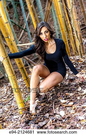19 year old brunette woman wearing a black top and shorts on a path in a bamboo forest. View Large Photo Image Stock Image - 19 year old brunette woman wearing a black top and shorts on a path in a bamboo forest.. Fotosearch