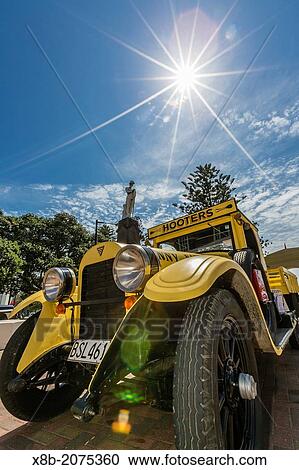 Stock Image - 1930's style Art Deco and automobiles on display in Napier, North Island, New Zealand.. Fotosearch