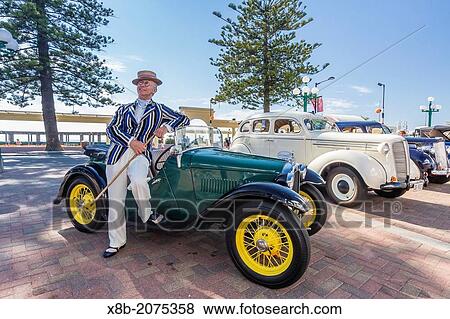 Stock Photo - 1930's style dress and Automobiles on display in Napier, North Island, New Zealand.. Fotosearch