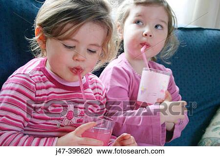 2, 3 year old girls drinking juice through a straw, looking off camera View Large Photo Image Stock Image - 2, 3 year old girls drinking juice through a straw, looking off camera. Fotosearch
