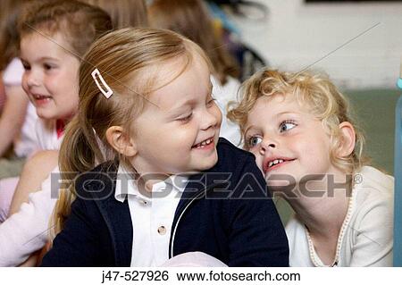 2, 4 year old girls sitting together, smiling at each other at nursery View Large Photo Image Stock Photograph - 2, 4 year old girls sitting together, smiling at each other at nursery. Fotosearch