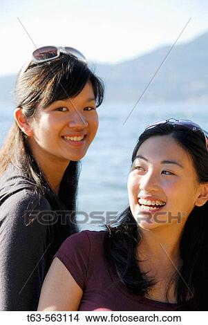 2 asian girls together on beach laughing View Large Photo Image Picture - 2 asian girls together on beach laughing. Fotosearch