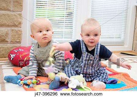 2 baby boys, 7months and 6 months, playing on the floor View Large Photo Image Stock Photograph - 2 baby boys, 7months and 6 months, playing on the floor. Fotosearch