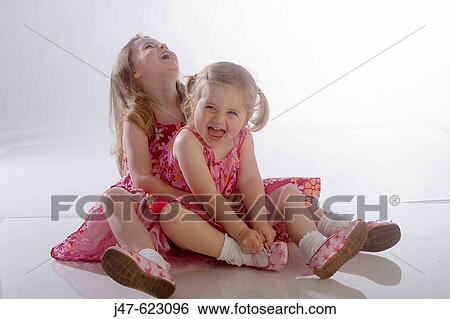 2 little girl, sitting on the floor, hugging and really laughing. View Large Photo Image Stock Photograph - 2 little girl, sitting on the floor, hugging and really laughing.. Fotosearch