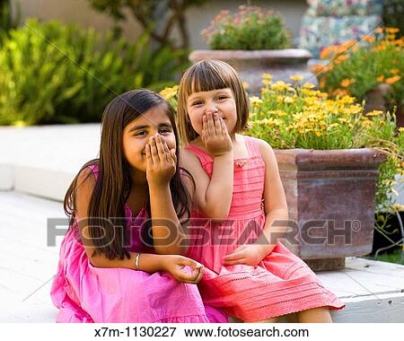 2 little girls, caucasian and Indian, talk and giggle on the porch View Large Photo Image Stock Photo - 2 little girls, caucasian and Indian, talk and giggle on the porch. Fotosearch