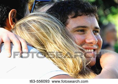 2 male, 1 female embracing together View Large Photo Image Stock Image - 2 male, 1 female embracing together. Fotosearch