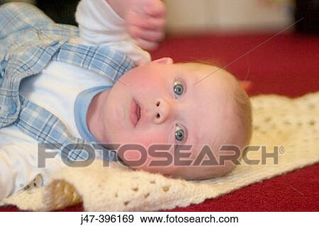 2 month old baby boy, lying on the floor looking up View Large Photo Image Stock Photo - 2 month old baby boy, lying on the floor looking up. Fotosearch