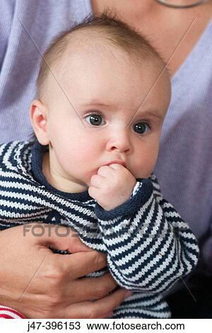 2 month old baby boy, sitting on mothers knee, hand to mouth, headshot View Large Photo Image Stock Image - 2 month old baby boy, sitting on mothers knee, hand to mouth, headshot. Fotosearch