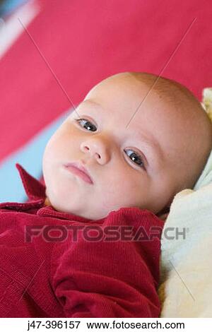2 month old baby in red dress lying on her back View Large Photo Image Stock Photo - 2 month old baby in red dress lying on her back. Fotosearch