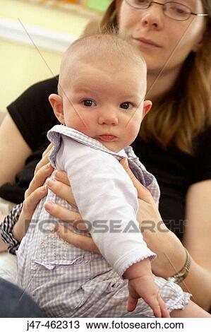 2 month old baby sitting on her mothers knee View Large Photo Image Stock Image - 2 month old baby sitting on her mothers knee. Fotosearch