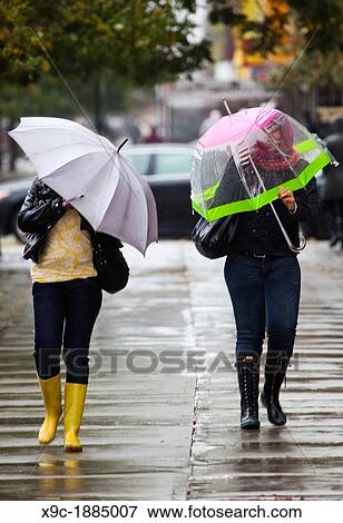 2 Women Walking in the Rain View Large Photo Image Stock Photo - 2 Women Walking in the Rain. Fotosearch