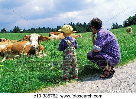 2 year old boy and mother looking at cows View Large Photo Image Stock Image - 2 year old boy and mother looking at cows. Fotosearch