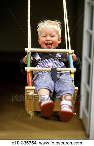 2 year old boy in the swing View Large Photo Image Picture - 2 year old boy in the swing. Fotosearch
