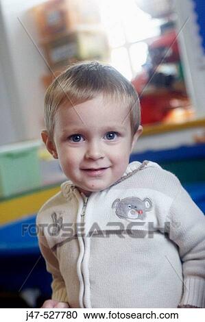 2 year old boy smiling into camera at nursery View Large Photo Image Stock Image - 2 year old boy smiling into camera at nursery. Fotosearch