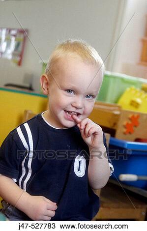 2 year old boy smiling into camera at nursery View Large Photo Image Stock Image - 2 year old boy smiling into camera at nursery. Fotosearch