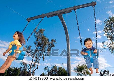 2 year old girl and 10 month old baby playing in swing at public park, Mesa. Arizona USA View Large Photo Image Stock Image - 2 year old girl and 10 month old baby playing in swing at public park, Mesa. Arizona USA. Fotosearch