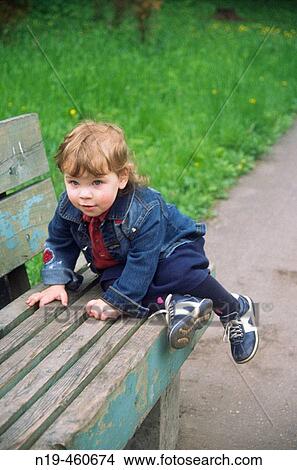 2 year old girl climb the bench View Large Photo Image Picture - 2 year old girl climb the bench. Fotosearch