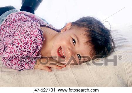 2 year old girl lying on tummy, laughing into camera View Large Photo Image Stock Image - 2 year old girl lying on tummy, laughing into camera. Fotosearch
