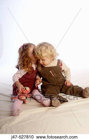 2 year old girl siting whispering to her little brother, in the studio View Large Photo Image Stock Image - 2 year old girl siting whispering to her little brother, in the studio. Fotosearch