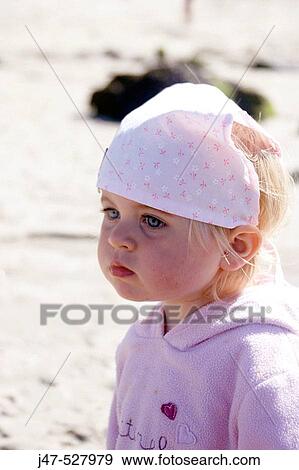 2 year old girl standing on the beach wearing a bandana View Large Photo Image Stock Photo - 2 year old girl standing on the beach wearing a bandana. Fotosearch