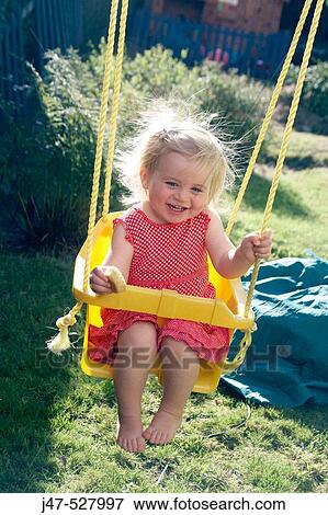 2 year old girl swinging View Large Photo Image Stock Photo - 2 year old girl swinging. Fotosearch