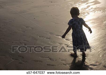 2 year old girl walking at the beach View Large Photo Image Stock Photo - 2 year old girl walking at the beach. Fotosearch