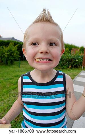 2 years boy making grimace with peace of bred in mouth, France View Large Photo Image Stock Photo - 2 years boy making grimace with peace of bred in mouth, France. Fotosearch