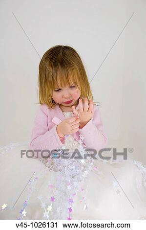 Stock Image - 2 years old girl dressed as a star princess.. Fotosearch