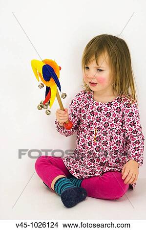2 years old girl playing with rattle toy. View Large Photo Image Picture - 2 years old girl playing with rattle toy.. Fotosearch