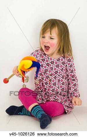 2 years old girl playing with rattle toy. View Large Photo Image Stock Photograph - 2 years old girl playing with rattle toy.. Fotosearch