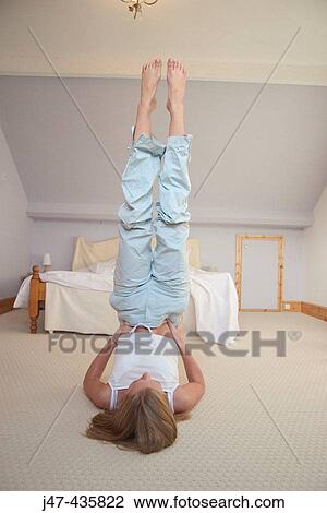 20 year old girl in her bedroom, practicing yoga - the inverted pose View Large Photo Image Stock Image - 20 year old girl in her bedroom, practicing yoga - the inverted pose. Fotosearch