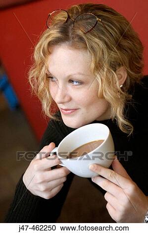 20 year old girl sitting in a bar with a cup of coffee View Large Photo Image Stock Image - 20 year old girl sitting in a bar with a cup of coffee. Fotosearch