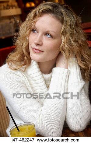 20 year old girl sitting in a bar with a glass of orange, looking off camera View Large Photo Image Stock Photo - 20 year old girl sitting in a bar with a glass of orange, looking off camera. Fotosearch