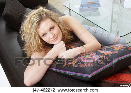 20 year old girl sitting on the sofa, smiling into camera View Large Photo Image Stock Image - 20 year old girl sitting on the sofa, smiling into camera. Fotosearch
